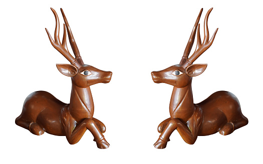 two wooden deers, old long horned wood deer sit and looking on white background, object, animal ,decor, gift, copy space