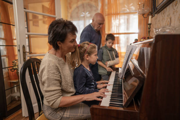 istock Girl learning to play the piano 1437219394