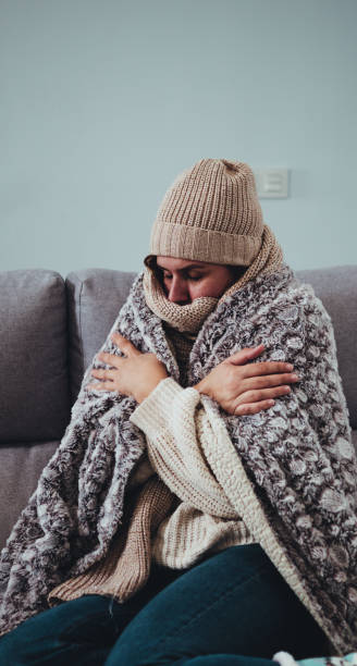 istock girl at home who is cold and is very warm 1437223653