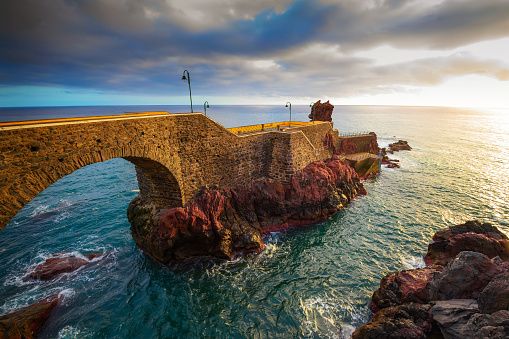 Sunset at the pier of Ponta do Sol in Madeira Island, Portugal.