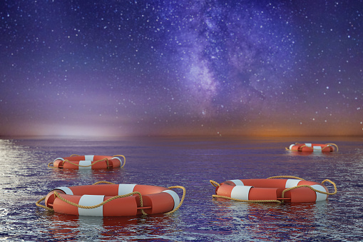 Life Buoys Floating on the Ocean at Night. 3D Render