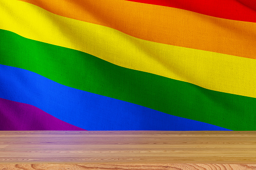 LGBTQIA Flag with Empty Wooden Surface. 3D Render