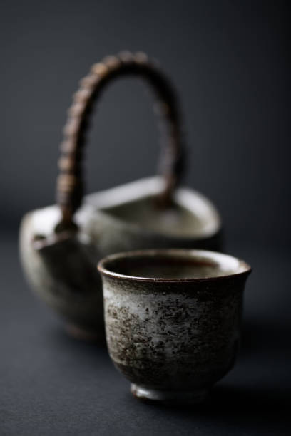 Traditional, handcrafted ceramic on dark background. Soft focus. Close up. Copy space