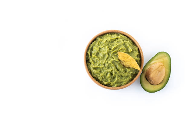 istock Mexican guacamole with nacho chip isolated on white background 1437230682