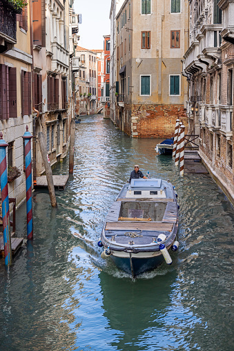 Venice, Italy - October 6th 2022:  One of the many motorboats which handles all transport of goods and garbage in the old and famous Italian city Venice