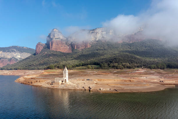 Aerial view of Sau Reservoir, in the Ter River, in the Province of Girona, Catalonia, Spain. Aerial view of Sau Reservoir, in the Ter River, in the Province of Girona, Catalonia, Spain. After months without rain the level of the swamp is very low. reservoir stock pictures, royalty-free photos & images