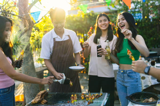 BBQ meeting of an Asian community when friends are happy. stock photo