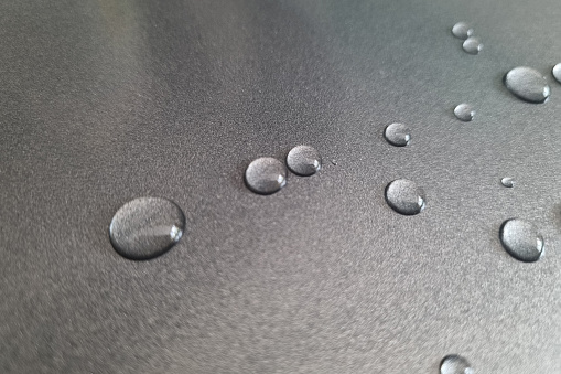 On the metal surface there are drops of water, background