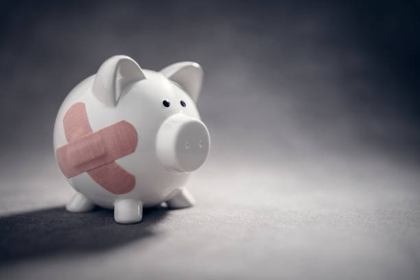 Broken piggy bank with band aid bandage or plaster finance background Broken piggy bank with band aid bandage or plaster finance background concept for economic crisis recession or bankruptcy debt recovery stock pictures, royalty-free photos & images