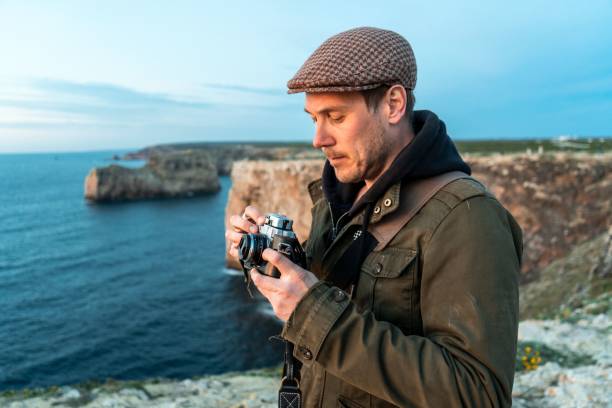 istock Tourist in Irish hat with vintage analog film camera on Cliffs 1437236789