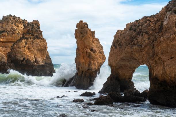 Rock Formation at Ponta da Piedade (Algarve) with splashings waves Rock Formation at Ponta da Piedade (Algarve) with splashings ocean waves tidal inlet stock pictures, royalty-free photos & images