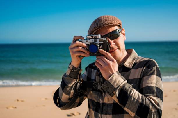 istock Tourist with Analog Film Camera on beach 1437236833