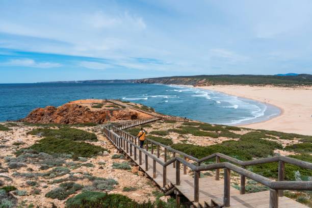 istock Scenic surf beach Praia da Bordeira with strong waves rolling in 1437236941