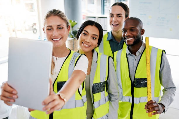 istock Happy, architects and team selfie with tablet at the office in collaboration and teamwork success. Group of diverse professional people smile in architecture business together in social collaboration 1437238154