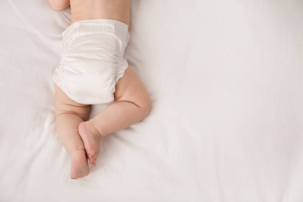 istock Little baby in diaper on bed, top view. Space for text 1437239088