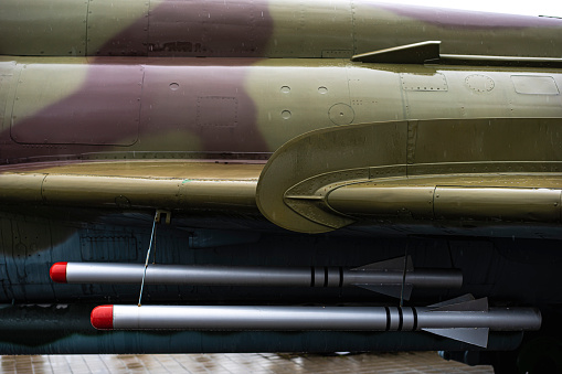 Close up shot of some fake rockets on an fighter jet plane.