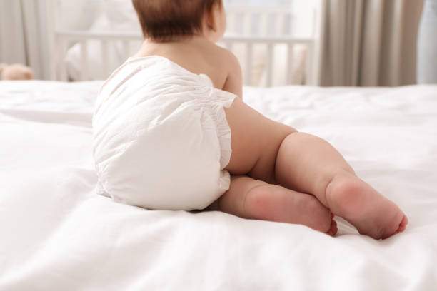 istock Little baby in diaper on bed at home, back view 1437239986