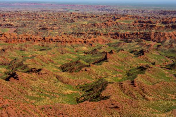 istock Mesmerizing scene of range rocky desert with green surface under blue sky 1437241756