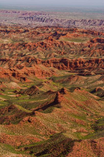 istock Vertical shot of range rocky desert with green surface with blue sky horizon 1437241757
