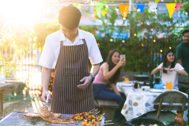 istock Asian men grilling BBQ, he smiles. 1437243406