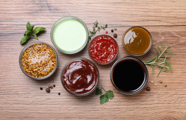istock Many different sauces on wooden table, flat lay 1437246140