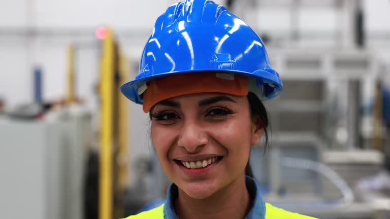 Happy engineer woman working inside robotic factory - Industrial and technology concept