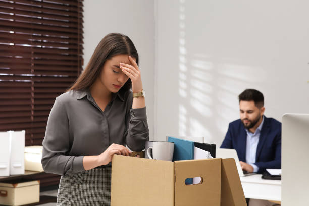 Dismissed woman packing personal stuff into box in office Dismissed woman packing personal stuff into box in office being fired photos stock pictures, royalty-free photos & images