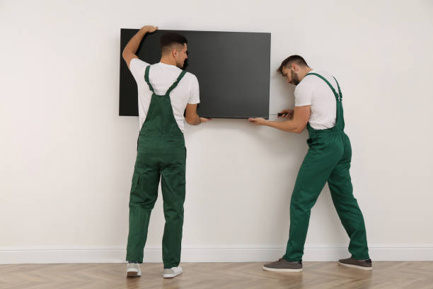 istock Professional technicians with screwdriver installing modern flat screen TV on wall indoors 1437246768