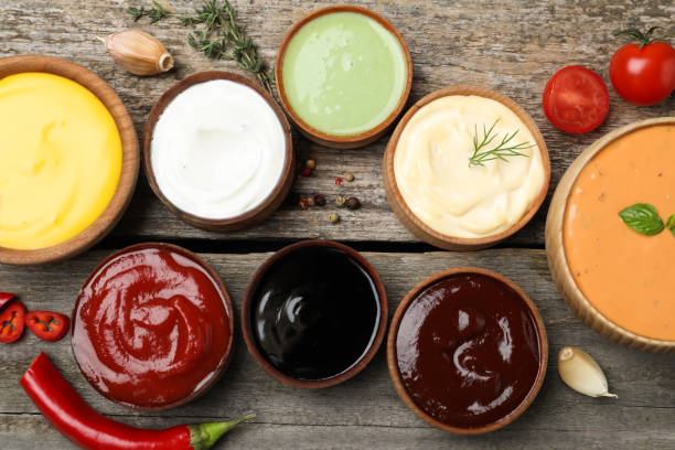 istock Many different sauces on wooden table, flat lay 1437246835