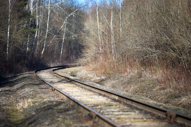 istock Railway track selective focus in the spring forest with blue sky with railway drainage system rail construction. Rail trackside drainage. Drainage channels of railway. 1437246856