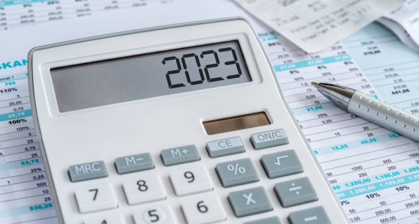a calculator with the 2023 on the display - tax imagens e fotografias de stock