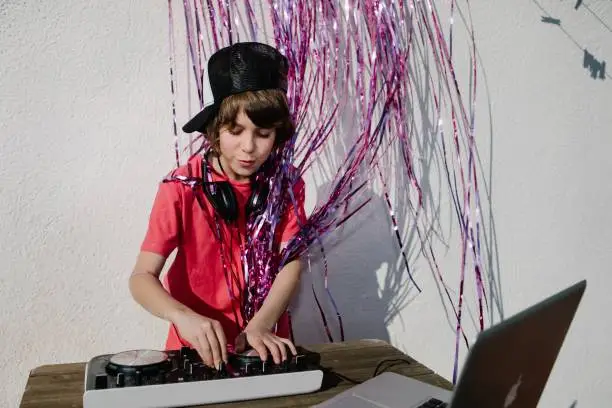 A young American boy near the DJ controller - the concept of DJing