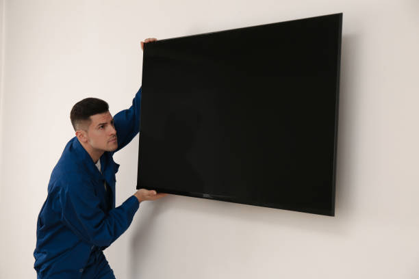 istock Professional technician installing modern flat screen TV on wall indoors 1437247955