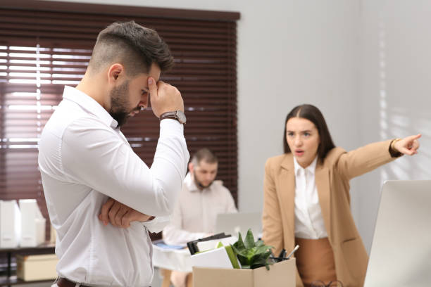 istock Boss dismissing young man from work in office 1437248042