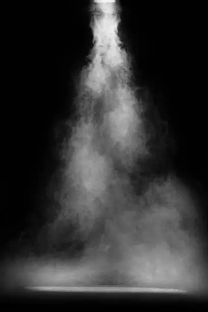 Photo of Empty stage dust, smoke or smog in the dark. Gray textured platform,