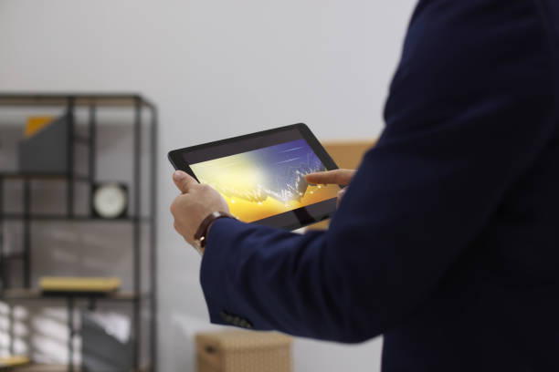 istock Businessman working with tablet in office, closeup. Forex trading 1437248632