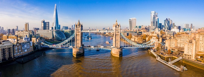 A panoramic shot of the Tower Bridge on the river Thames under a blue clear sky, London