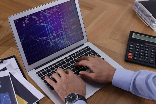 istock Businessman working with laptop at table, closeup. Forex trading 1437249520