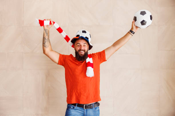 istock Football fan having fun cheering while watching the game 1437250294
