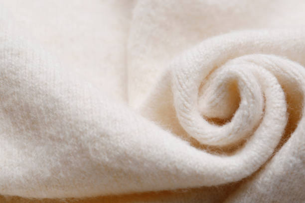 istock Soft beige knitted fabric as background, top view 1437250443