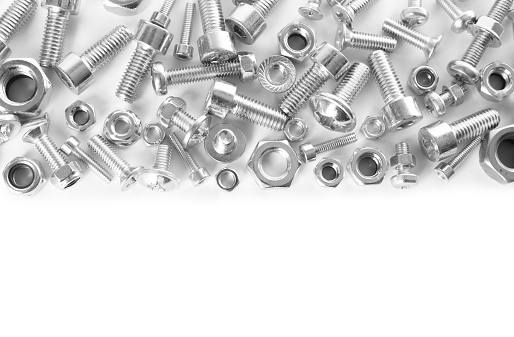Different metal bolts and nuts on white background, top view