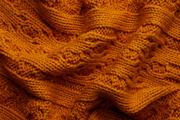 istock Beautiful orange knitted fabric as background, top view 1437250595