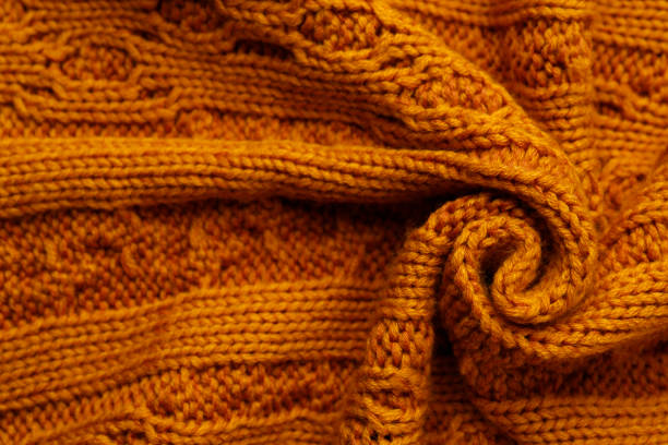istock Beautiful orange knitted fabric as background, top view 1437251611
