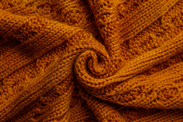 istock Beautiful orange knitted fabric as background, top view 1437252426