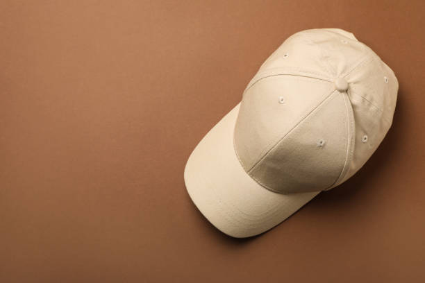 istock Baseball cap on brown background, top view. Space for text 1437252767