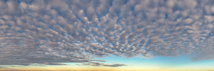 A panoramic skyscape with altocumulus clouds.