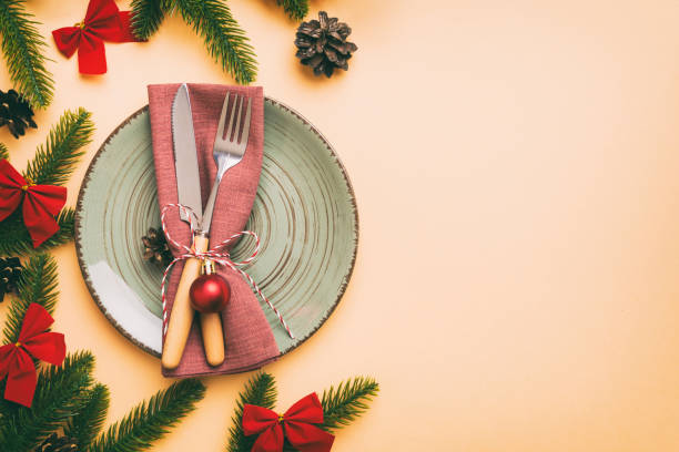 istock Christmas table place setting with christmas decor and plates, kine, fork and spoon. Christmas holiday background. Top view with copy space 1437254219