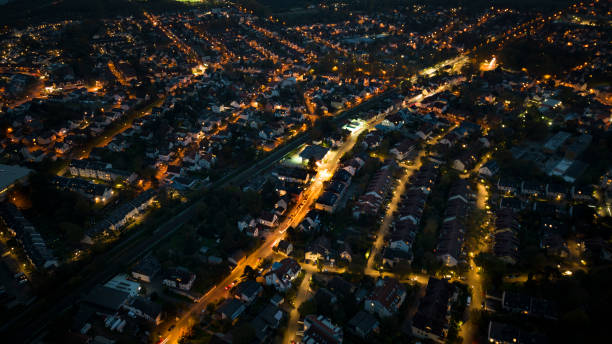 istock Aerial view over illuminated city at dusk 1437254309