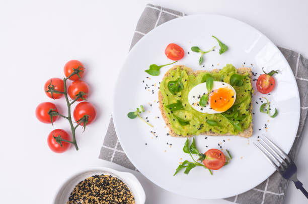 istock Bread with avocado , vegetables fruit and egg on white background , Healthy breakfast concept 1437256536