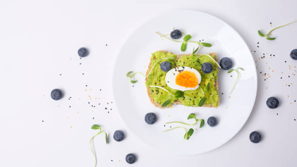 istock Bread with avocado , vegetables fruit and egg on white background , Healthy breakfast concept 1437256620